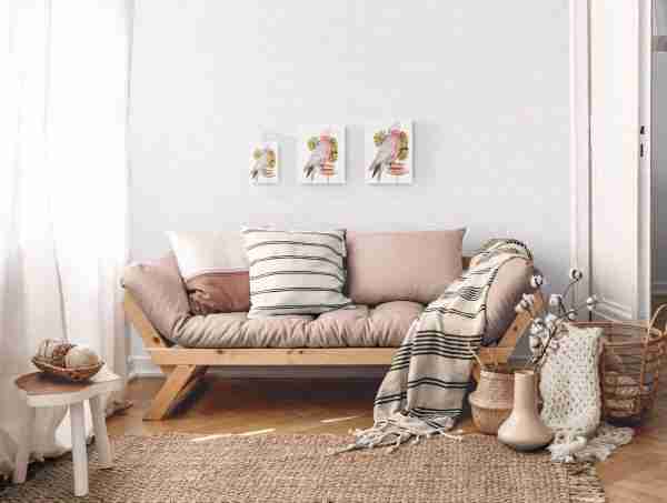 Three sizes of art print featuring a pink galah, in a neutral coloured living room