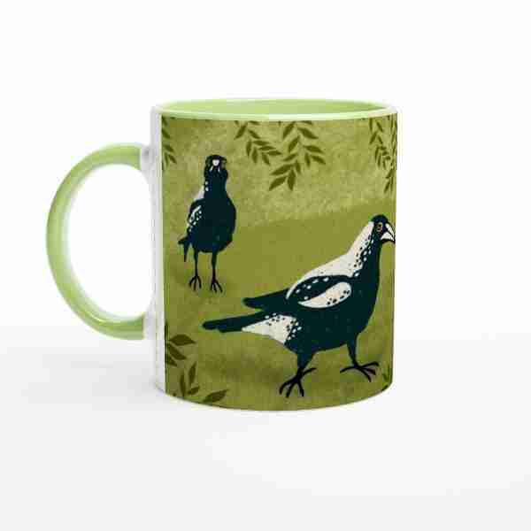 Wildlife-themed ceramic coffee cup showcasing Australian magpies in a garden