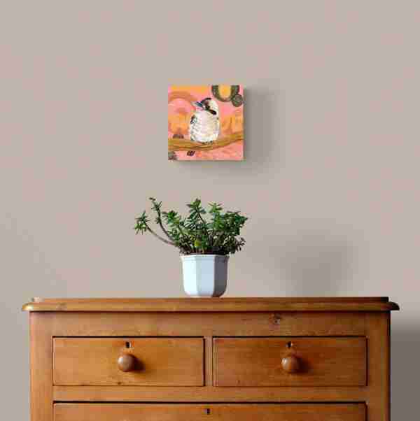 Wall with wooden drawers and a plant on top with a kookaburra bird print displayed