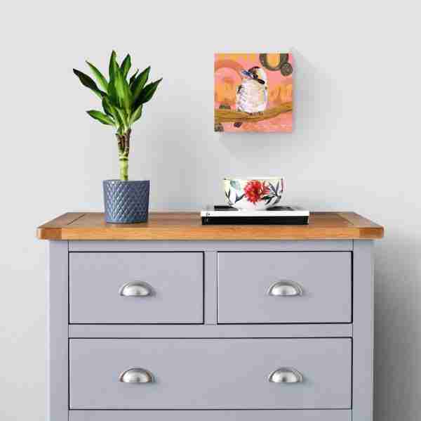 A grey cabinet against a wall displaying a kookaburra bird print